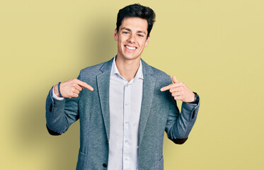 Young hispanic man wearing business clothes looking confident with smile on face, pointing oneself...