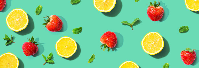Fresh lemons and strawberries with mints overhead view - flat lay