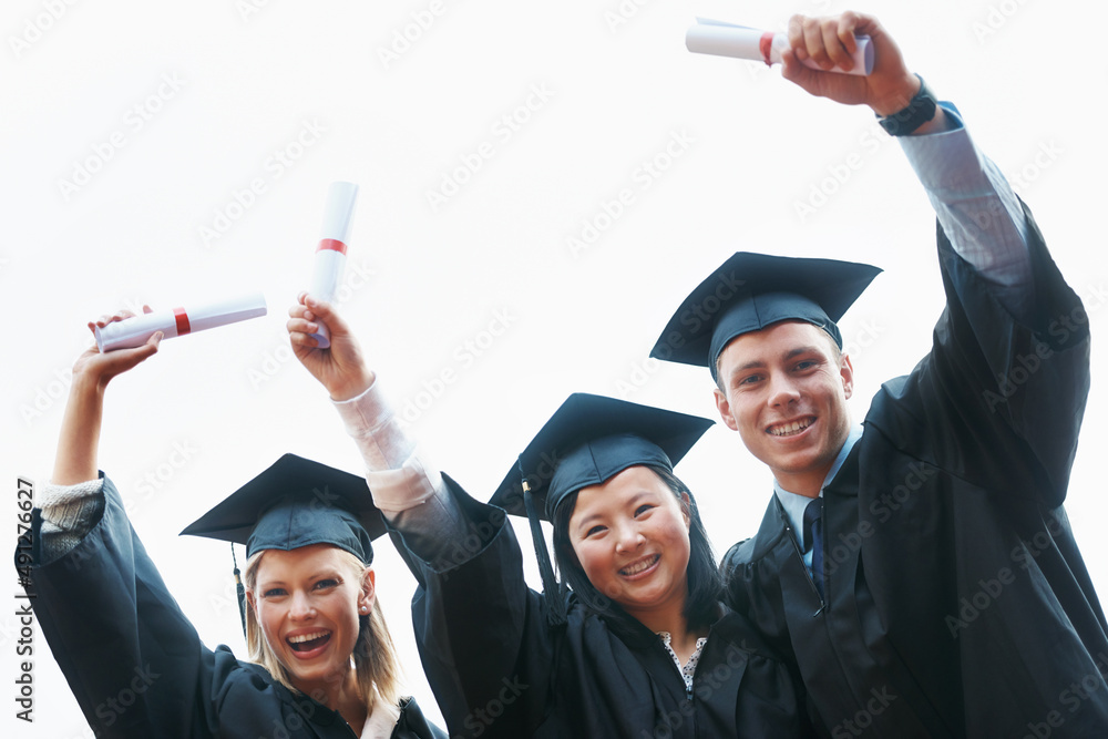 Poster Were going to mark our mark on the world. A group of enthusiastic college graduates holding up their diplomas.