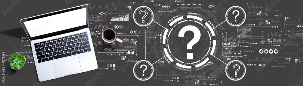 Poster question marks with a laptop computer on a desk