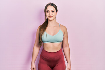 Young hispanic girl wearing sportswear with a happy and cool smile on face. lucky person.