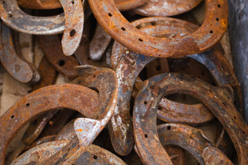 Old used horseshoes stacked in a pile