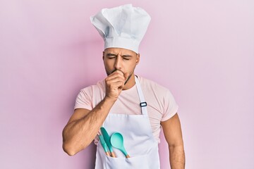 Young arab man wearing professional cook apron and hat feeling unwell and coughing as symptom for...