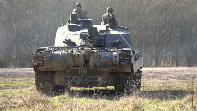 British army FV4034 Challenger 2 main battle tank with the commander and gunner directing action on a military exercise, Wiltshire UK