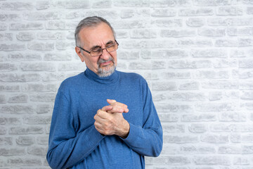 Old man with finger pain