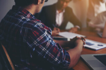 A group of business people are meeting to analyze data for marketing plan