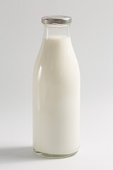 Glass bottle with milk on a white background