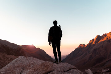 Man is climbing, hiking in the mountains.