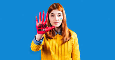 Girl with red hand and written stop war to protest against violence