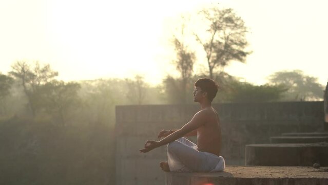 young boy working out and doing yoga early in the morning.Healthy lifestyle conept.