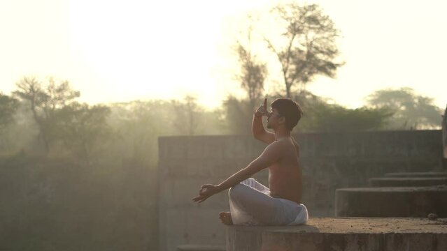 young boy working out and doing yoga early in the morning.Healthy lifestyle conept.