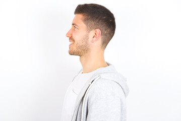 Profile of smiling young caucasian man wearing casual clothes over white background  with healthy...