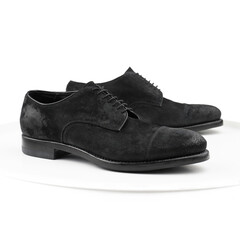 Black suede derby on a white background