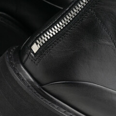 Black leather boots heel with zip detail closeup