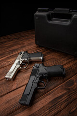 Two guns. Short-barreled weapons in black and silver. Weapons for self-defense. Two pistols on a...