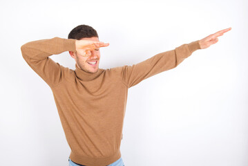 Photo of funky young caucasian man wearing knitted turtleneck over white background show disco move...
