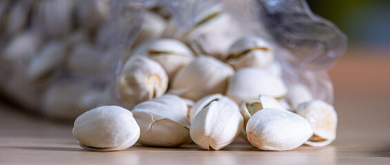 Closeup nut in a plastic bag on a wooden table, selective focus