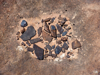 Weathered and oxidized flat stones in dust, Bears Ears desert wilderness area of Southern Utah.