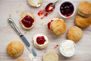 Delicious british scones with strawberry jam and clotted cream - obrazy, fototapety, plakaty