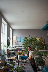 Professional tranquil floral decorator planting a succulent