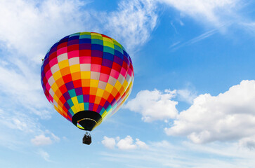 Colorful hot air balloon flying over blue sky