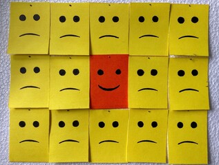 Be different concept. sad faces and one smiling face
