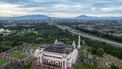 Aerial view of At Tin Grand Mosque, where this mosque is the largest mosque in Indonesia which is located in East Jakarta with mountain view. Jakarta, Indonesia, March 8, 2022