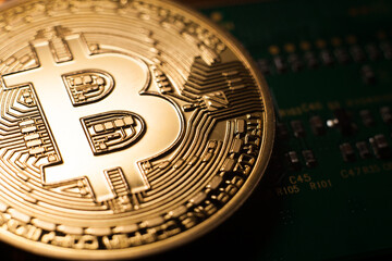 Bitcoin coin on green circuit background. Cryptocurrency, virtual money. Blockchain technology, bitcoin mining concept.
