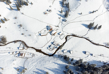 a top view with a mountainous rural area in winter
