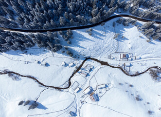a top view with a mountainous rural area in winter