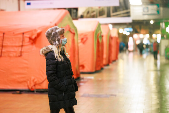 Ukrainian woman refugee. Pray for Ukraine. Stop the war in Ukraine. War refugees in the train station near tents