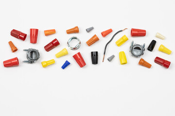 Horizontal flat layout of assorted color wire nuts and connectors and wire on white background