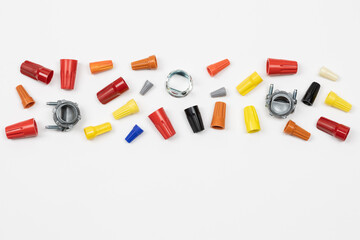 Horizontal flat layout of assorted color wire nuts and connectors on white background