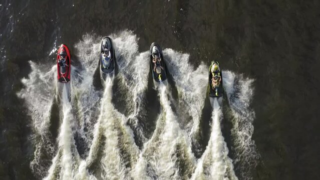 Group of jet skis rushes along the Dnieper with the flags of Ukraine. Summer. Aerial. 