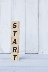 start word or concept on wooden blocks, white wood background