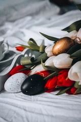 Foto op Plexiglas Sill life spring white and red tulips with golden, black and white easter eggs © Lucie