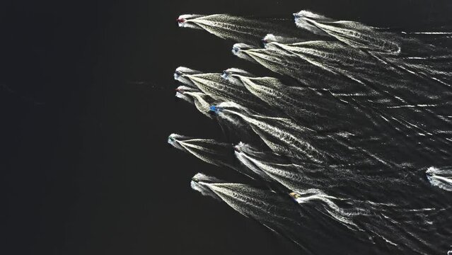 Group of jet skis rushes along the Dnieper with the flags of Ukraine. Summer. Aerial. 