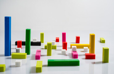 top view of colored cubes and bars on a white surface	
