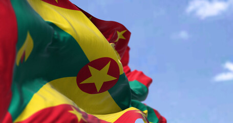 Detail of the national flag of Grenada waving in the wind on a clear day