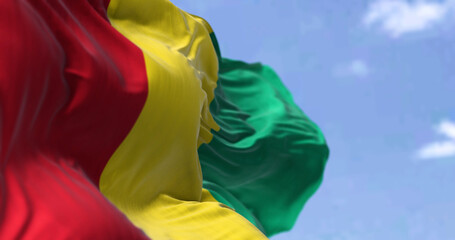Detail of the national flag of Guinea waving in the wind on a clear day