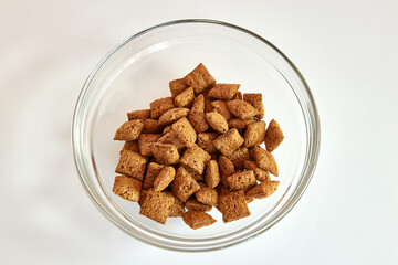 Granola in a transparent bowl on a white background. Healthy food.