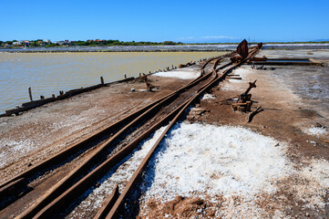 Vintage railway. Old rails at a salt factory. Sea salt. Blue sky. The photo.