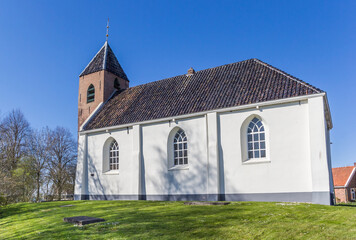 Little white church in historic village Mensingeweer, Netherlands