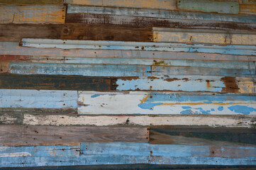 Vintage wooden background, blue, gray, yellow, pink, painted aged board.