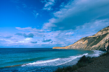 Fototapeta na wymiar High cliff by the ocean, beautiful ocean view, beautiful sky with white clouds