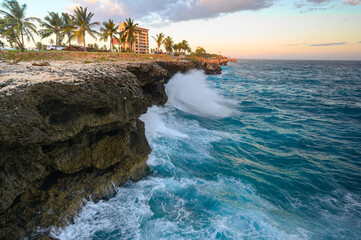Raging ocean, rocky coast at sunset. Malecon in Santo Domingo. Caribbean travel