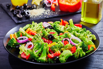 Broccoli salad with paprika, sesame seeds, olives