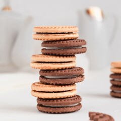 Fototapeta na wymiar Stack of milk and chocolate cookies with cream filling. Bakery concept.