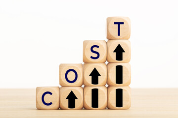 Cost growth concept. Text and Arrow icon on wooden blocks. Copy space