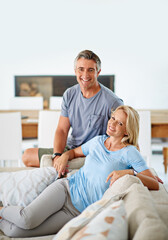 We live a contented life. Portrait of a loving mature couple relaxing at home.